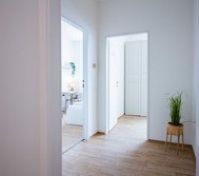 Bright hallway connecting apartment rooms