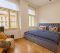 Bright bedroom with double bed and chair