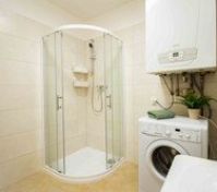 Bathroom with shower and washing machine