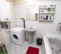 Bathroom with tub and washing machine