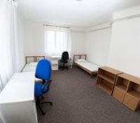 Twin bedroom with desks and shelves
