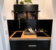 Modern black kitchen with induction hob