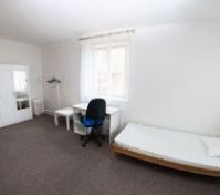 Single bedroom with desk and wardrobe