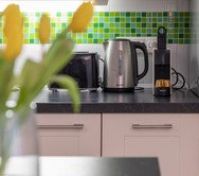 Kitchen counter with appliances and flowers