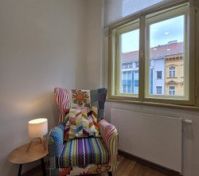 Colorful armchair reading nook by window