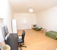 Spacious bedroom with two beds desk