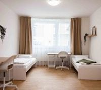 Twin bedroom with desks and window