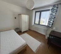 Bright bedroom with white wardrobe