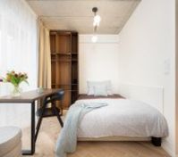 Bedroom with desk and wooden shelves