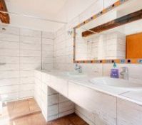 Full shower is available in the corner with curtain. 