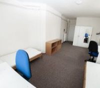 Spacious bedroom with wardrobe and desks