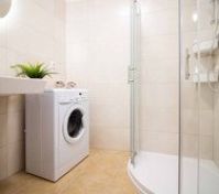 Bathroom with shower and washing machine