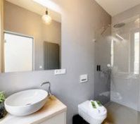 Bathroom with walk-in shower and mirror
