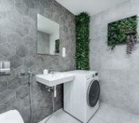 Green accents add a fresh touch, while the in-unit washer ensures convenience. A perfect blend of elegance and functionality for a comfortable stay.
