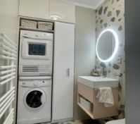 Toilet and laundry room downstairs.