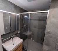 Bathroom with glass shower and vanity