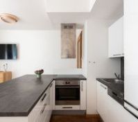 Modern kitchen with oven and TV