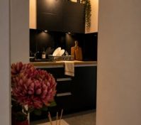 Compact black kitchen with LED lighting