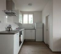 White kitchen with appliances and window