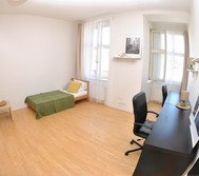 Bright bedroom with bed and desk