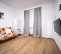 Sofa bed , smart tv and wardrobe in in spacious bedroom 