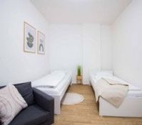 Twin bedroom with sofa and decor