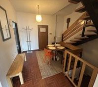 Entryway with dining table staircase