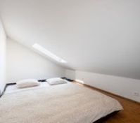 Loft bedroom with sloped ceiling