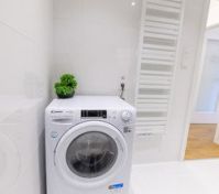 Bathroom with washing machine and radiator
