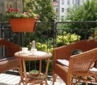 The terrace is furnished with rattan chairs, a coffee table. 